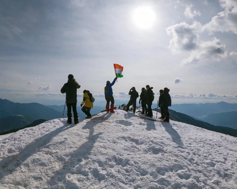 Group at the Brahmatal summit holding the Indian flag